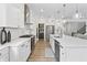 Bright kitchen featuring stainless steel appliances, white countertops and cabinetry, and tile backsplash at 2223 Ryder Pl, Westfield, IN 46074