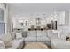 Bright living room area with a large sectional sofa and open view to the modern, white kitchen at 2223 Ryder Pl, Westfield, IN 46074