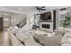 Comfortable living room with a large sectional, fireplace with television, and hardwood floors at 2223 Ryder Pl, Westfield, IN 46074