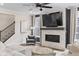 Stylish living room featuring a marble fireplace, TV, ceiling fan, and staircase at 2223 Ryder Pl, Westfield, IN 46074
