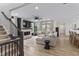 Open concept living room with a large sectional and an open staircase at 2223 Ryder Pl, Westfield, IN 46074