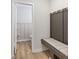 Convenient mudroom area with a bench, coat hooks, and access to a well-appointed powder room at 2223 Ryder Pl, Westfield, IN 46074