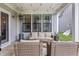 Relaxing covered patio with wicker furniture, heater, and stylish swing, perfect for outdoor living and entertaining at 2223 Ryder Pl, Westfield, IN 46074