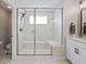 The glass-enclosed shower features bench seating, a rain shower head, and bright natural light at 2223 Ryder Pl, Westfield, IN 46074