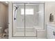 The glass-enclosed shower is roomy and features marble tiling, bench seating, and modern fixtures at 2223 Ryder Pl, Westfield, IN 46074