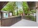 Spacious backyard with mature trees, grass, and a shed viewed from the deck at 233 N Devon Ave, Indianapolis, IN 46219