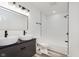 Bathroom with double sinks, black fixtures, and a shower and tub combo at 233 N Devon Ave, Indianapolis, IN 46219