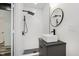 Modern bathroom featuring a sleek vanity and a shower with white subway tiles and black fixtures at 233 N Devon Ave, Indianapolis, IN 46219