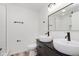 Modern bathroom featuring double sinks, black hardware, and sleek design, offering a spa-like retreat at 233 N Devon Ave, Indianapolis, IN 46219