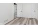 Neutral bedroom featuring light hardwood floors, white walls and white doors at 233 N Devon Ave, Indianapolis, IN 46219
