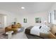 Stylishly decorated bedroom with a modern bed, sitting area, and natural light from windows at 233 N Devon Ave, Indianapolis, IN 46219