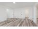 Spacious bedroom with wood-style flooring, multiple doors, and neutral tones, offering a blank canvas at 233 N Devon Ave, Indianapolis, IN 46219