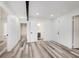 Spacious bedroom with modern gray flooring, white walls, and access to an ensuite bathroom at 233 N Devon Ave, Indianapolis, IN 46219