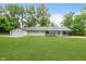 Charming single-story home with a well-maintained lawn and a bright turquoise front door at 233 N Devon Ave, Indianapolis, IN 46219