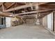 Unfinished garage showing exposed wood rafters and lots of open space at 233 N Devon Ave, Indianapolis, IN 46219