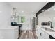 Bright kitchen featuring white cabinets, stainless steel appliances, and modern design at 233 N Devon Ave, Indianapolis, IN 46219
