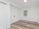 Clean, bright room with wood flooring, and a natural light window, creating a versatile living space at 233 N Devon Ave, Indianapolis, IN 46219