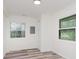 Bright, airy room with wood flooring and natural light, perfect for a flexible living space at 233 N Devon Ave, Indianapolis, IN 46219