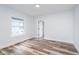 Bright bedroom features a large window, new hardwood flooring, and a spacious closet at 2531 E Brookside Ave, Indianapolis, IN 46218