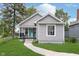 Charming home with a well-maintained lawn and a bright turquoise front door at 2531 E Brookside Ave, Indianapolis, IN 46218