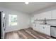 Bright kitchen features new stainless appliances, white cabinets, and modern flooring at 2531 E Brookside Ave, Indianapolis, IN 46218