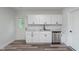 Modern kitchen with sleek white cabinets, stainless steel appliances, and updated fixtures at 2531 E Brookside Ave, Indianapolis, IN 46218