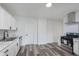 Bright, remodeled kitchen with stainless steel appliances, white cabinetry and modern fixtures at 2531 E Brookside Ave, Indianapolis, IN 46218