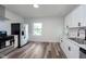 Modern kitchen with stainless steel appliances, white cabinets, and tile backsplash at 2531 E Brookside Ave, Indianapolis, IN 46218