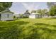 Expansive backyard view with a shed, green lawn, and neighboring homes at 2631 Collier St, Indianapolis, IN 46241