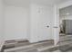 A view of an empty basement room with new flooring and access to the kitchen at 2631 Collier St, Indianapolis, IN 46241