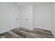 Bedroom features wood-look flooring and two white doors with black handles at 2631 Collier St, Indianapolis, IN 46241