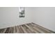 Minimalist bedroom showcasing wood-look flooring and a bright window at 2631 Collier St, Indianapolis, IN 46241