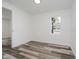Bright bedroom featuring wood-look floors, a window view, and neutral wall paint at 2631 Collier St, Indianapolis, IN 46241