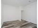 Clean bedroom design with wood-look floors, closet, and white door at 2631 Collier St, Indianapolis, IN 46241