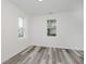 Bright, empty bedroom with a window showing a neighborhood scene, showcasing a clean, inviting space at 2631 Collier St, Indianapolis, IN 46241
