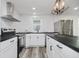 Modern kitchen with stainless steel appliances, white cabinets, and black countertops at 2631 Collier St, Indianapolis, IN 46241