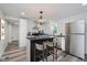 A modern kitchen features an island with seating, sleek appliances, and ample counter space at 2631 Collier St, Indianapolis, IN 46241