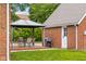 Backyard patio boasts a gazebo with outdoor dining set, adjacent to brick building at 2645 Washington St, Columbus, IN 47201