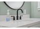 Bright bathroom featuring a modern faucet, sleek countertops, and a stylish round mirror at 2645 Washington St, Columbus, IN 47201