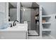 Modern bathroom with a glass-enclosed shower, stylish vanity, and convenient shelving at 2645 Washington St, Columbus, IN 47201