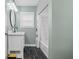 Bathroom featuring a black marble floor, a new vanity, and a shower with subway tile at 2645 Washington St, Columbus, IN 47201