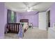Comfortable bedroom with a wood bed frame, neutral carpet and lavender walls at 2645 Washington St, Columbus, IN 47201
