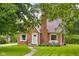 Charming brick home with a well-manicured lawn, inviting front entrance, and cozy outdoor seating at 2645 Washington St, Columbus, IN 47201