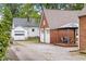 View of detached garages and a patio featuring an outdoor dining set at 2645 Washington St, Columbus, IN 47201