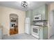 Updated kitchen featuring sage cabinetry, stainless appliances, and an adjacent dining area at 2645 Washington St, Columbus, IN 47201