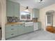 Charming updated kitchen with light green cabinetry, butcher block countertops, and a white farmhouse sink at 2645 Washington St, Columbus, IN 47201