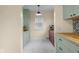 Updated kitchen featuring sage cabinetry, butcher block countertops, and white tile flooring at 2645 Washington St, Columbus, IN 47201