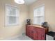 Additional kitchen space featuring a red cabinet and two windows with natural light at 2645 Washington St, Columbus, IN 47201
