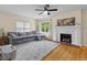 Cozy living room with hardwood floors, a fireplace, and a comfortable grey sofa at 2645 Washington St, Columbus, IN 47201