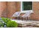 Comfortable outdoor seating area with stylish chairs, a small table, and beautiful landscaping at 2645 Washington St, Columbus, IN 47201